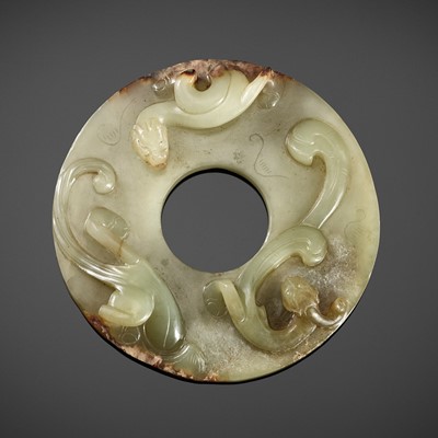 A CELADON JADE DISC WITH COILED DRAGONS, WESTERN HAN DYNASTY