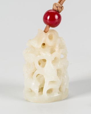 A PALE CELADON JADE RETICULATED COURT HAT FINIAL, YUAN DYNASTY