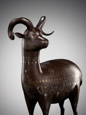Lot 244 - A QAJAR SILVER- AND GOLD-DAMASCENED IRON FIGURE OF AN IBEX, PERSIA, 19TH CENTURY