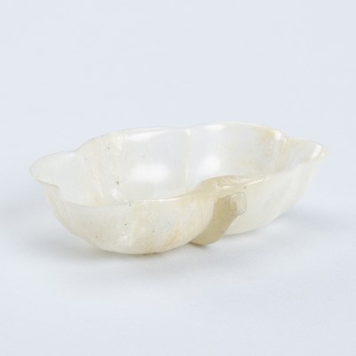 Lot 884 - A MUGHAL-STYLE JADE ‘LOTUS’ WASHER, QING DYNASTY