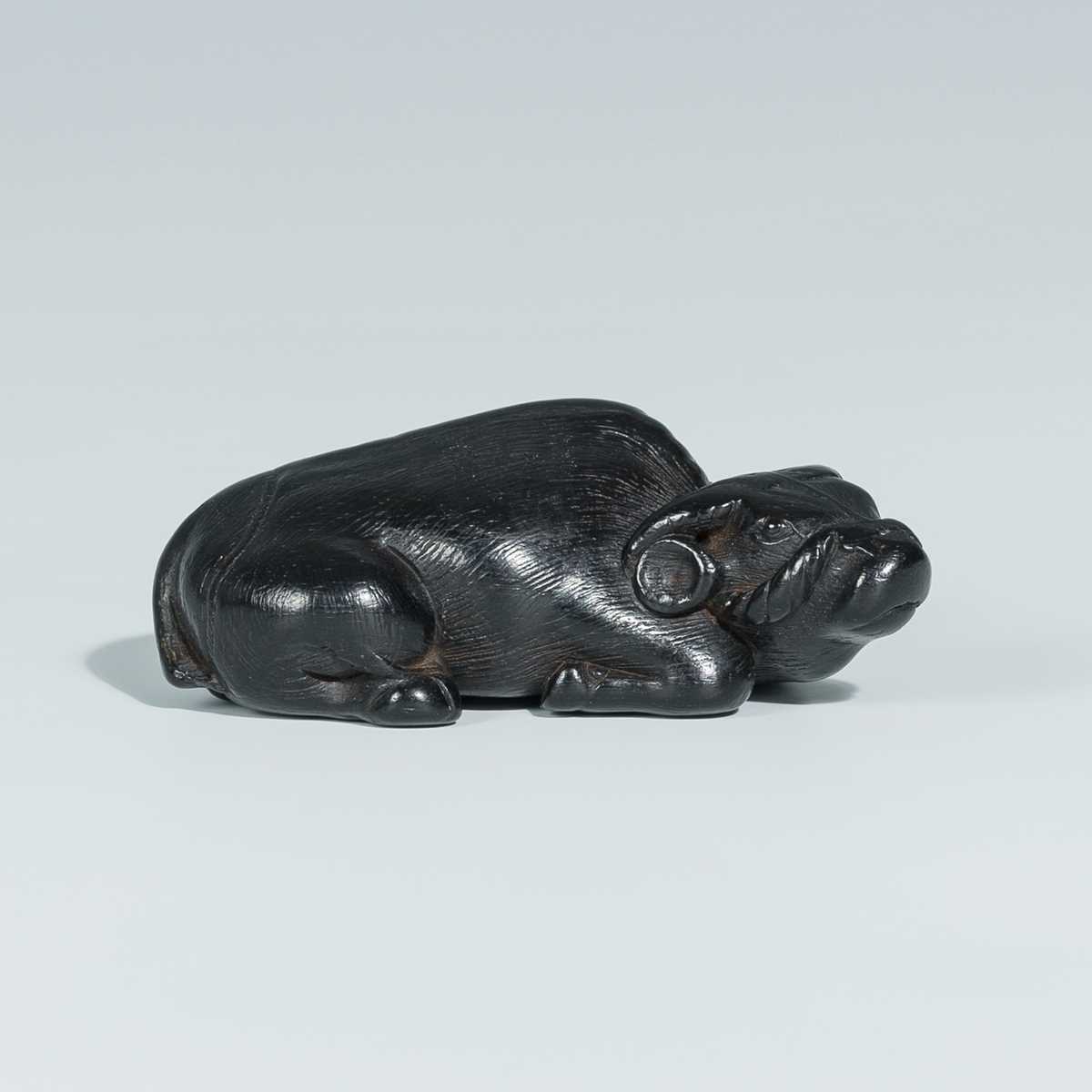 Lot 397 - A GOOD EBONY WOOD NETSUKE OF AN OX