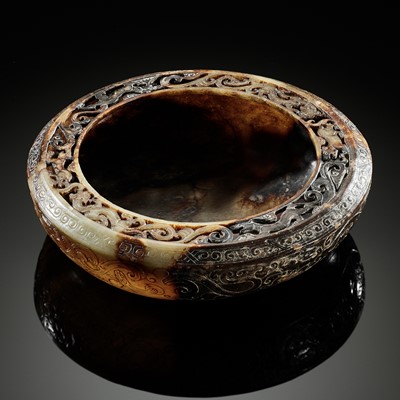 A VERY RARE PALE CELADON AND RUSSET JADE ‘COILING DRAGONS’ BASIN, HAN DYNASTY
