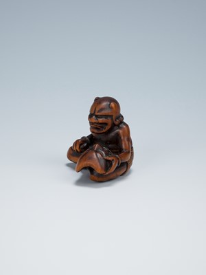 Lot 389 - GYOKKEI: A WOOD NETSUKE OF AN ONI INSPECTING A SHOKI MASK