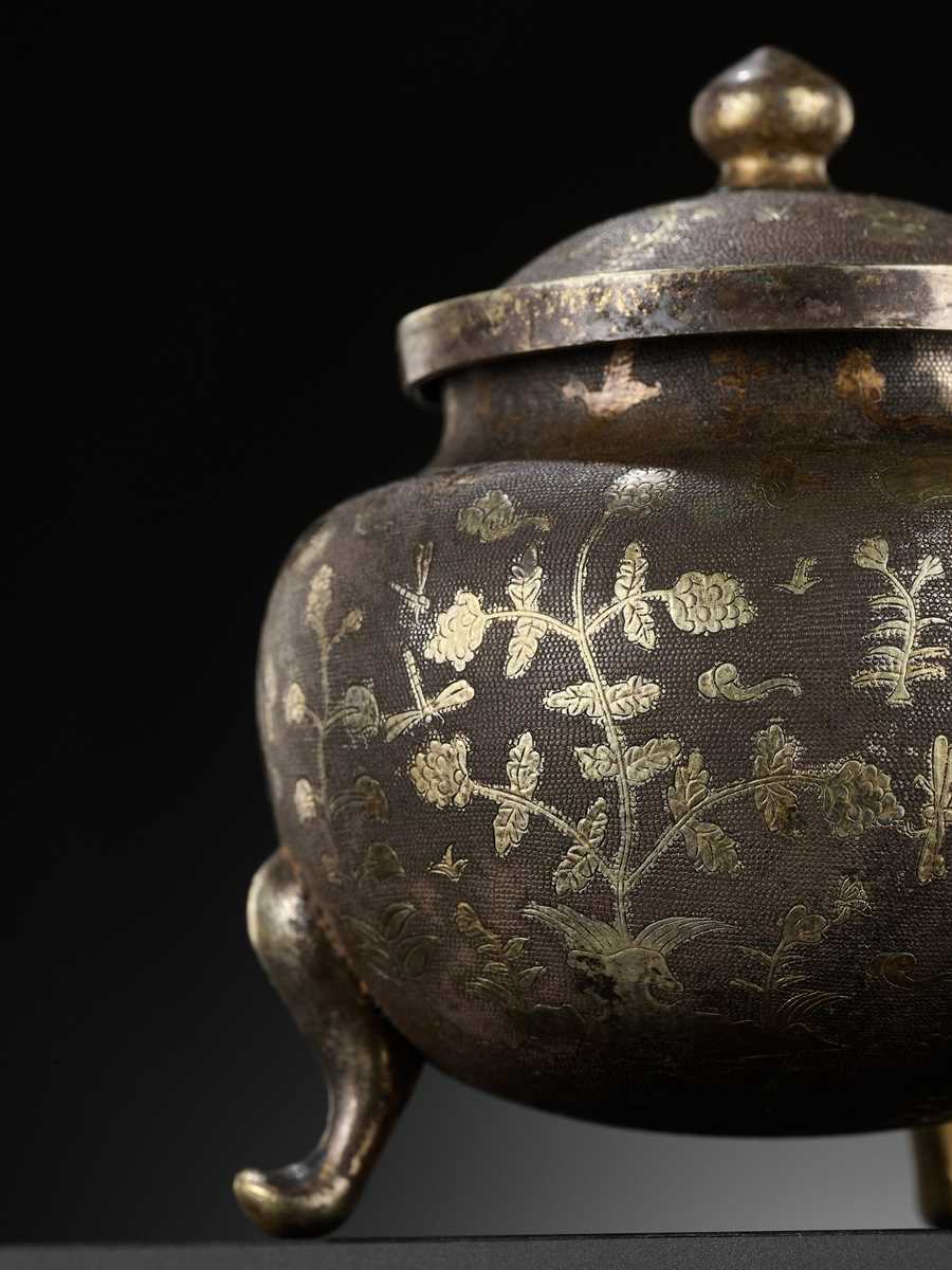 Lot 157 - A PARCEL-GILT SILVER TRIPOD JAR AND COVER, TANG DYNASTY