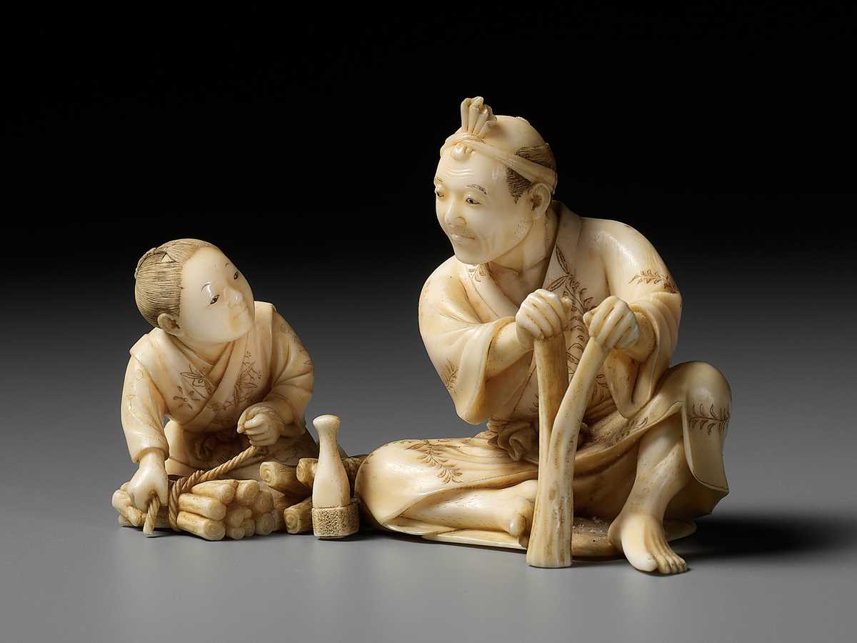 Lot 162 - HIROYUKI: AN IVORY OKIMONO OF A WOODCUTTER WITH CHILD