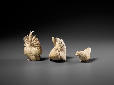 Lot 152 - A GROUP OF IVORY OKIMONO DEPICTING ROOSTERS WITH HEN