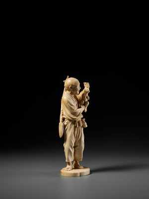 Lot 138 - KOSEI: A FINE TOKYO SCHOOL IVORY OKIMONO OF A HUNTER HOLDING A HARE