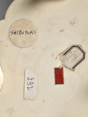 Lot 283 - SEISHI: A FINE AND RARE IVORY OKIMONO OF A WOODBLOCK PRINT MAKER WITH HIS SON