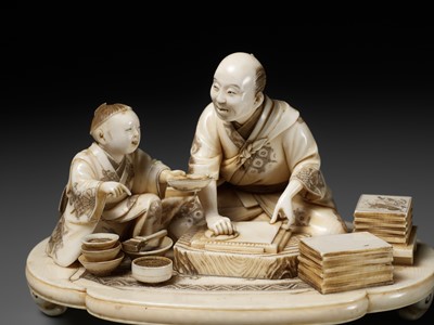 Lot 283 - SEISHI: A FINE AND RARE IVORY OKIMONO OF A WOODBLOCK PRINT MAKER WITH HIS SON