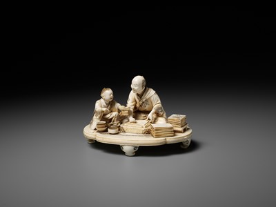 Lot 283 - SEISHI: A FINE AND RARE IVORY OKIMONO OF A WOODBLOCK PRINT MAKER WITH HIS SON