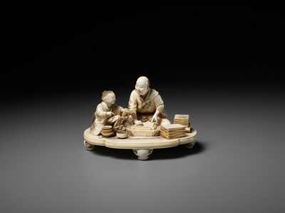 Lot 283 - SEISHI: A FINE AND RARE IVORY OKIMONO OF A WOODBLOCK PRINT MAKER WITH HIS SON