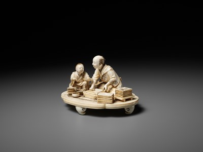 Lot 283 - SEISHI: A FINE AND RARE IVORY OKIMONO OF A WOODBLOCK PRINT MAKER WITH HIS SON