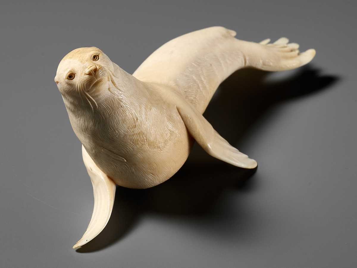 Lot 149 - ITASAKA KASON: A VERY RARE IVORY OKIMONO DEPICTING A RECUMBENT SEA LION