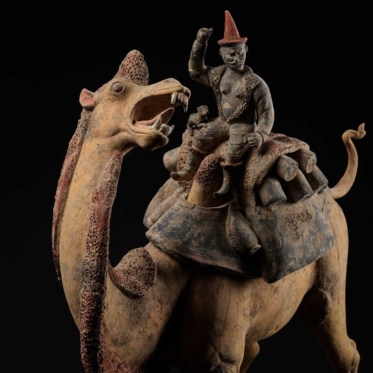 Lot 66 - AN EXCEPTIONALLY LARGE PAINTED POTTERY FIGURE OF A BACTRIAN CAMEL AND A SOGDIAN RIDER, TANG DYNASTY