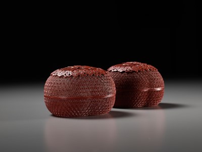 Lot 7 - A PAIR OF HEAVY CARVED CINNABAR LACQUER PEACH-FORM BOXES AND COVERS DEPICTING IMMORTALS, QIANLONG PERIOD