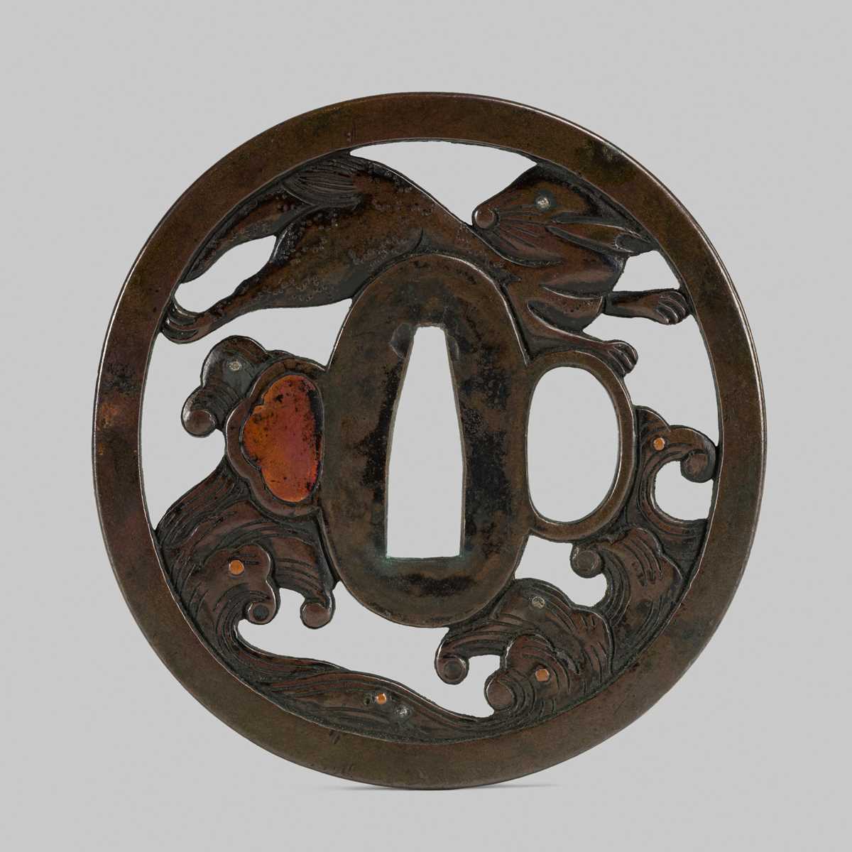 Lot 292 - SHOAMI YUKIMITSU: A FINE SHIBUICHI TSUBA DEPICTING THE WHITE HARE OF INABA LEAPING OVER WAVES