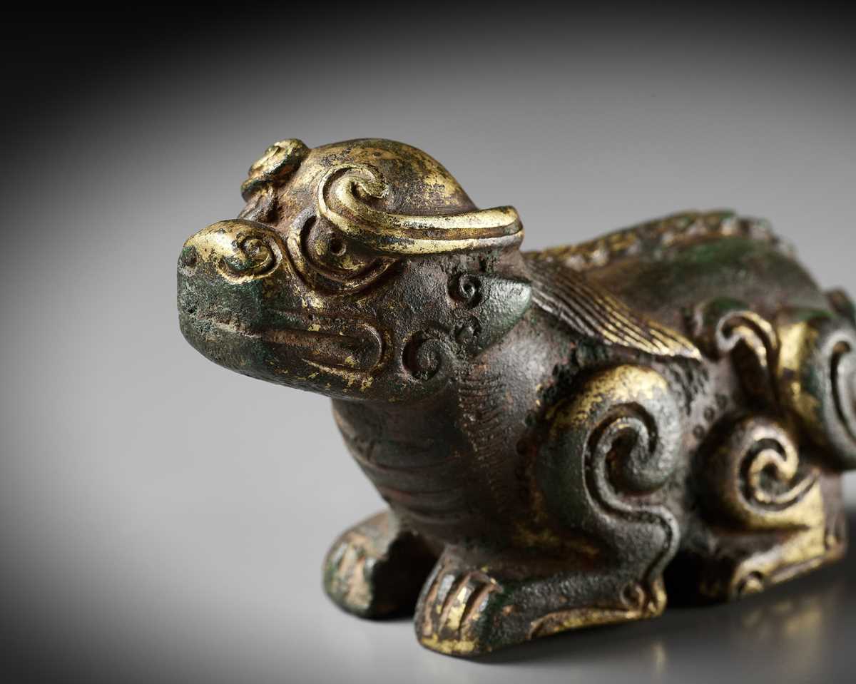 Lot 163 - A GILT BRONZE LION-FORM WEIGHT, LATE MING DYNASTY