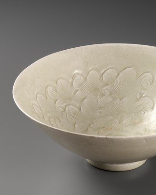 Lot 505 - A CARVED QINGBAI ‘CLOUD SCROLL’ BOWL, SONG DYNASTY