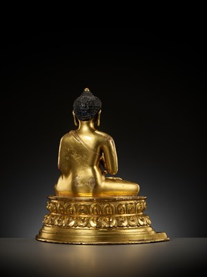 Lot 179 - A GILT COPPER ALLOY FIGURE OF AMOGHASIDDHI, ONE OF THE FIVE WISDOM BUDDHAS, POSSIBLY DENSATIL, TIBET, 14TH-15TH CENTURY