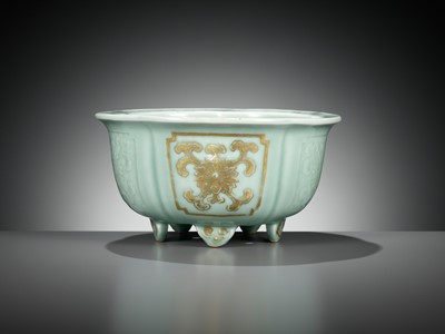 Lot 114 - A MOLDED, LOBED AND GILT CELADON-GLAZED JARDINIÈRE, QIANLONG MARK AND PERIOD