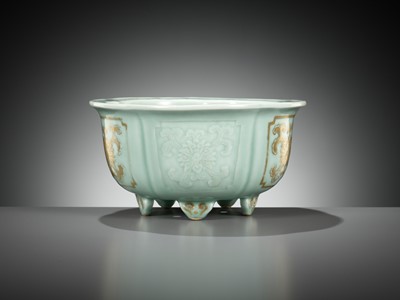 Lot 114 - A MOLDED, LOBED AND GILT CELADON-GLAZED JARDINIÈRE, QIANLONG MARK AND PERIOD