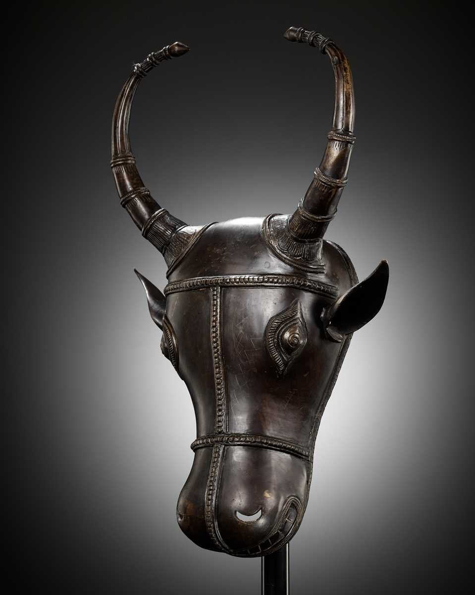 Lot 302 - A BRONZE BHUTA CULT MASK OF NANDI, SOUTH INDIA, LATE 18TH TO EARLY 19TH CENTURY