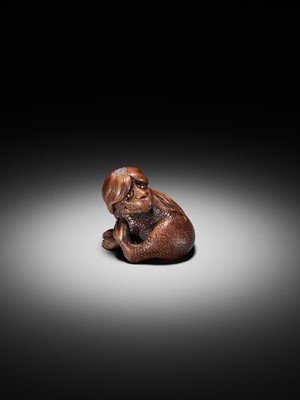 Lot 194 - SUKEYUKI: A SUPERB WOOD NETSUKE OF A LONG-HAIRED KAPPA