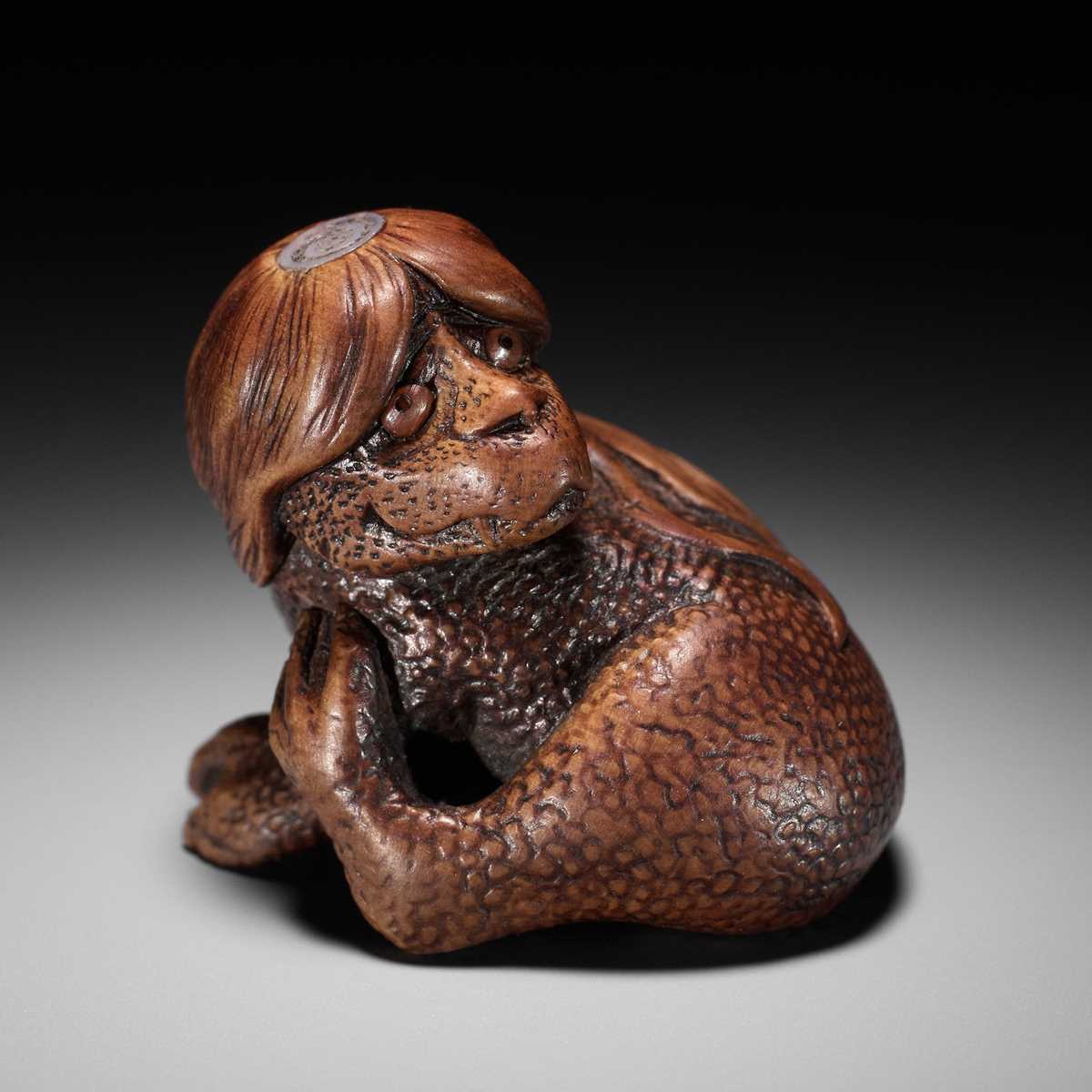 Lot 194 - SUKEYUKI: A SUPERB WOOD NETSUKE OF A LONG-HAIRED KAPPA