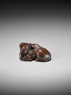 A LARGE AND UNUSUAL WOOD NETSUKE OF A RECUMBENT OX
