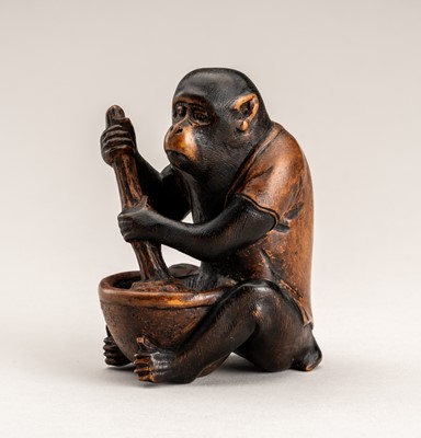 Lot 572 - A WOOD OKIMONO OF A MONKEY STIRRING MISO, MEIJI