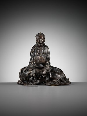 Lot 661 - A BRONZE FIGURE OF WENSHU (MANJUSHRI) ON A LION, LATE MING TO EARLY QING DYNASTY