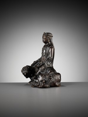 Lot 661 - A BRONZE FIGURE OF WENSHU (MANJUSHRI) ON A LION, LATE MING TO EARLY QING DYNASTY