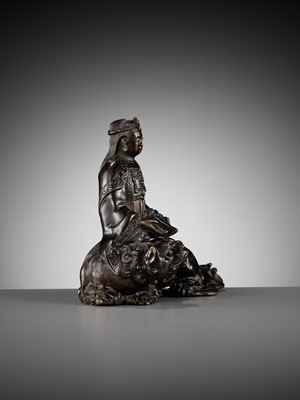 Lot 661 - A BRONZE FIGURE OF WENSHU (MANJUSHRI) ON A LION, LATE MING TO EARLY QING DYNASTY