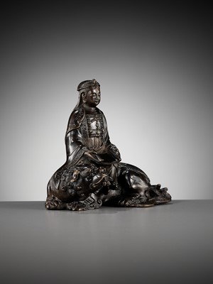 Lot 661 - A BRONZE FIGURE OF WENSHU (MANJUSHRI) ON A LION, LATE MING TO EARLY QING DYNASTY