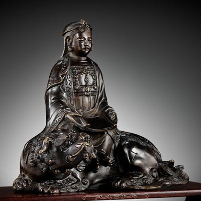 Lot 661 - A BRONZE FIGURE OF WENSHU (MANJUSHRI) ON A LION, LATE MING TO EARLY QING DYNASTY