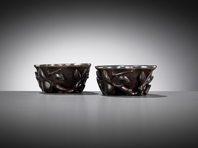 Lot 16 - A PAIR OF SILVER-LINED ZITAN ‘MAGNOLIA’ LIBATION CUPS, CHINA, 18TH CENTURY