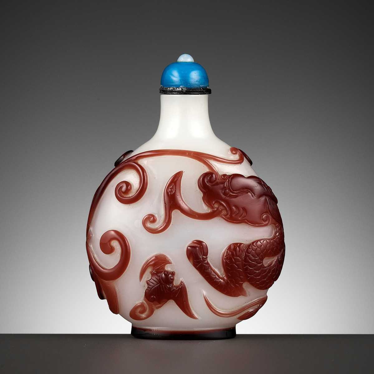 Lot 378 - A RED OVERLAY GLASS 'DRAGON AND PHOENIX'