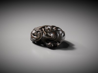 Lot 111 - A BRONZE ‘BUDDHIST LION’ SCROLL WEIGHT, LATE MING DYNASTY