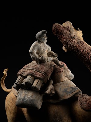 Lot 67 - AN EXCEPTIONALLY LARGE PAINTED POTTERY FIGURE OF A BACTRIAN CAMEL WITH RIDER, MONKEY AND SLAIN GOATS, TANG DYNASTY