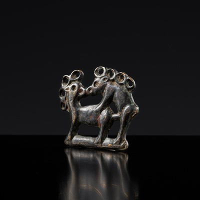 Lot 94 - AN ORDOS BRONZE ‘COPULATING STAGS’ PLAQUE, EASTERN ZHOU