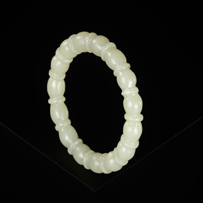 Lot 459 - A PALE CELADON JADE ‘BAMBOO’ BANGLE, LATE QING DYNASTY TO REPUBLIC PERIOD