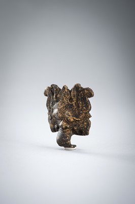 A GILT BRONZE TAOTIE MASK FITTING, WARRING STATES TO HAN DYNASTY