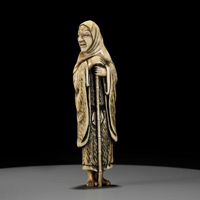 A RARE IVORY NETSUKE OF AN ACTOR IN THE ROLE OF THE FOX PRIEST (HAKUZOSU)