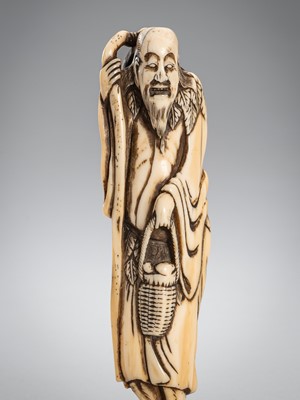 Lot 1496 - A TALL IVORY NETSUKE OF A SENNIN
