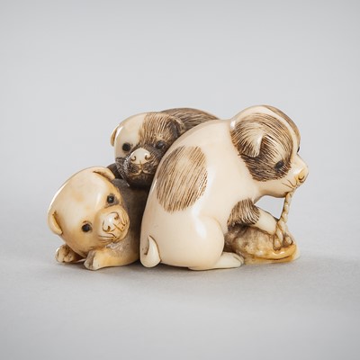 Lot 1543 - HIDECHIKA: A CHARMING IVORY NETSUKE OF THREE PUPPIES