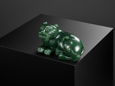 Lot 28 - A RARE SPINACH-GREEN JADE FIGURE OF A TIGER, SECOND HALF OF THE QIANLONG PERIOD
