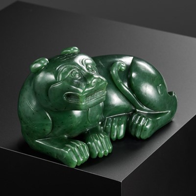 Lot 28 - A RARE SPINACH-GREEN JADE FIGURE OF A TIGER, SECOND HALF OF THE QIANLONG PERIOD