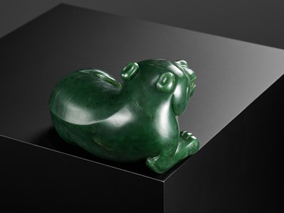 Lot 28 - A RARE SPINACH-GREEN JADE FIGURE OF A TIGER, SECOND HALF OF THE QIANLONG PERIOD