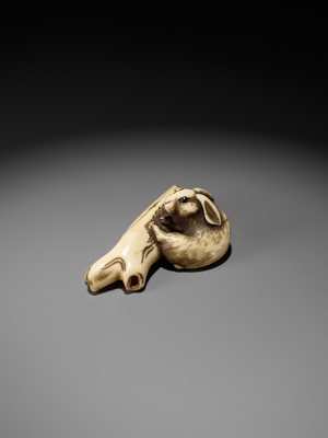 Lot 145 - A SUPERB OSAKA SCHOOL IVORY NETSUKE OF A RABBIT WITH TREE BRANCH