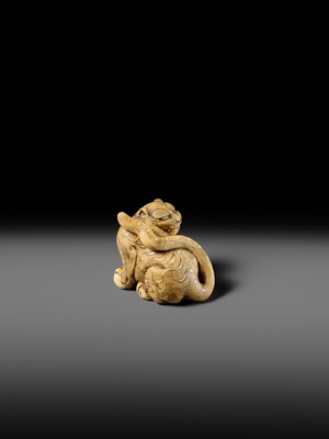 Lot 151 - A POWERFUL OSAKA SCHOOL IVORY NETSUKE OF A CROUCHING TIGER